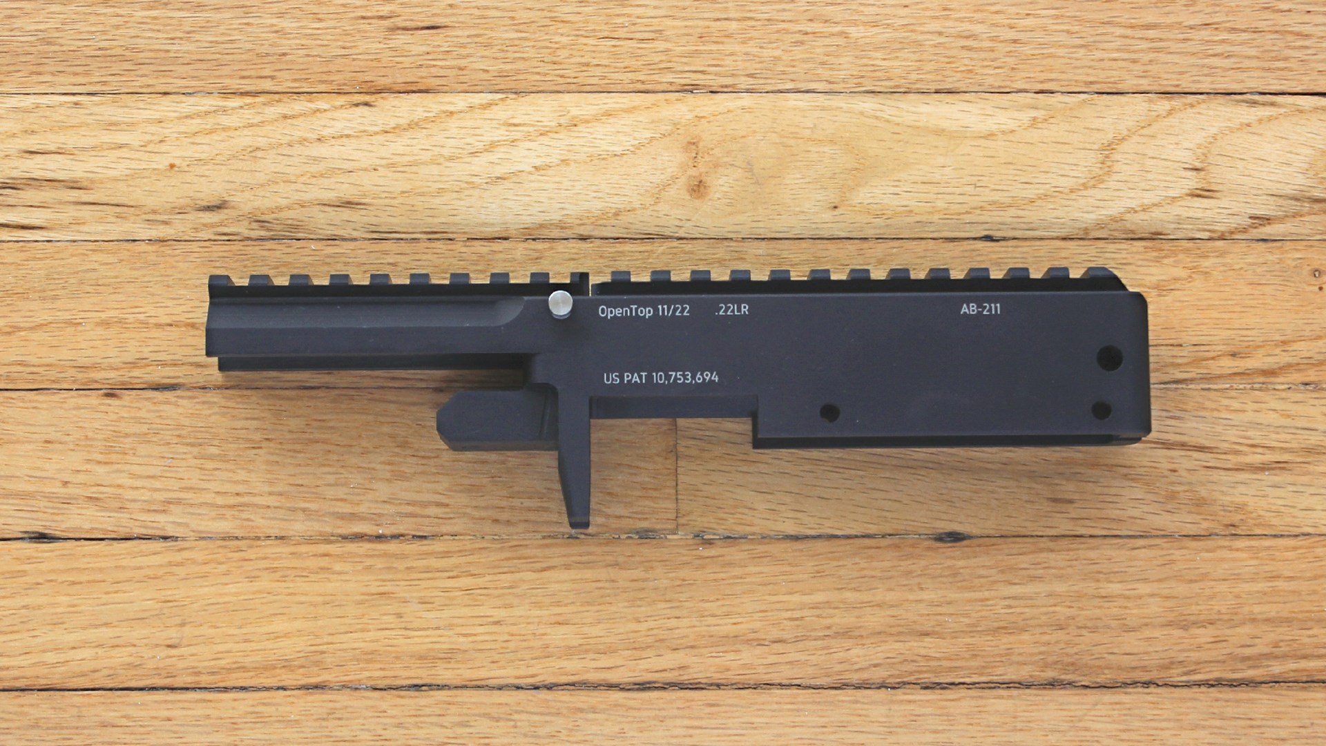 Fletcher Rifle Works OpenTop 11/22 black rifle receiver shown on wood floor