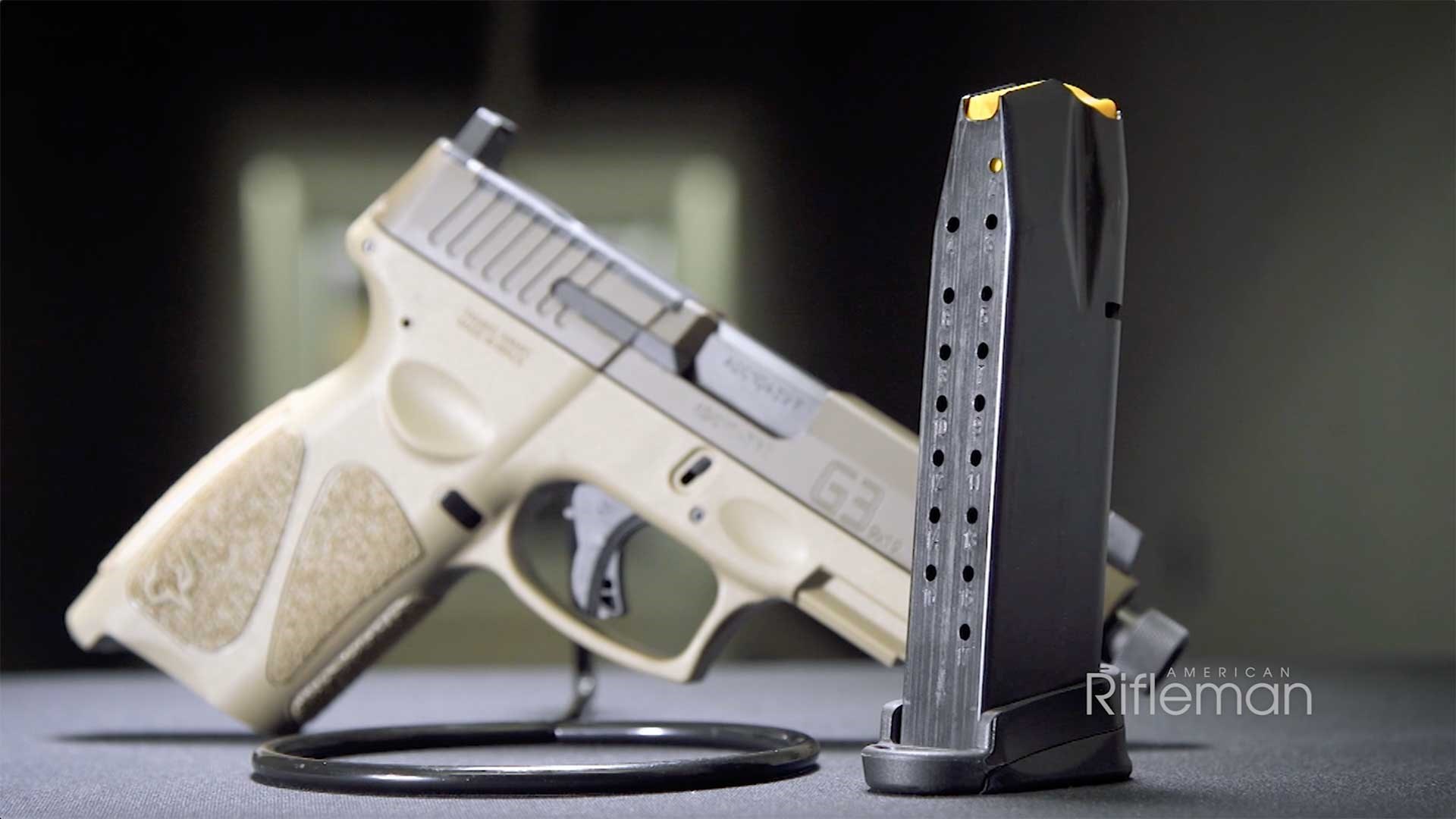 An empty 17-round magazine stands in front of a propped-up Taurus G3 Tactical pistol.