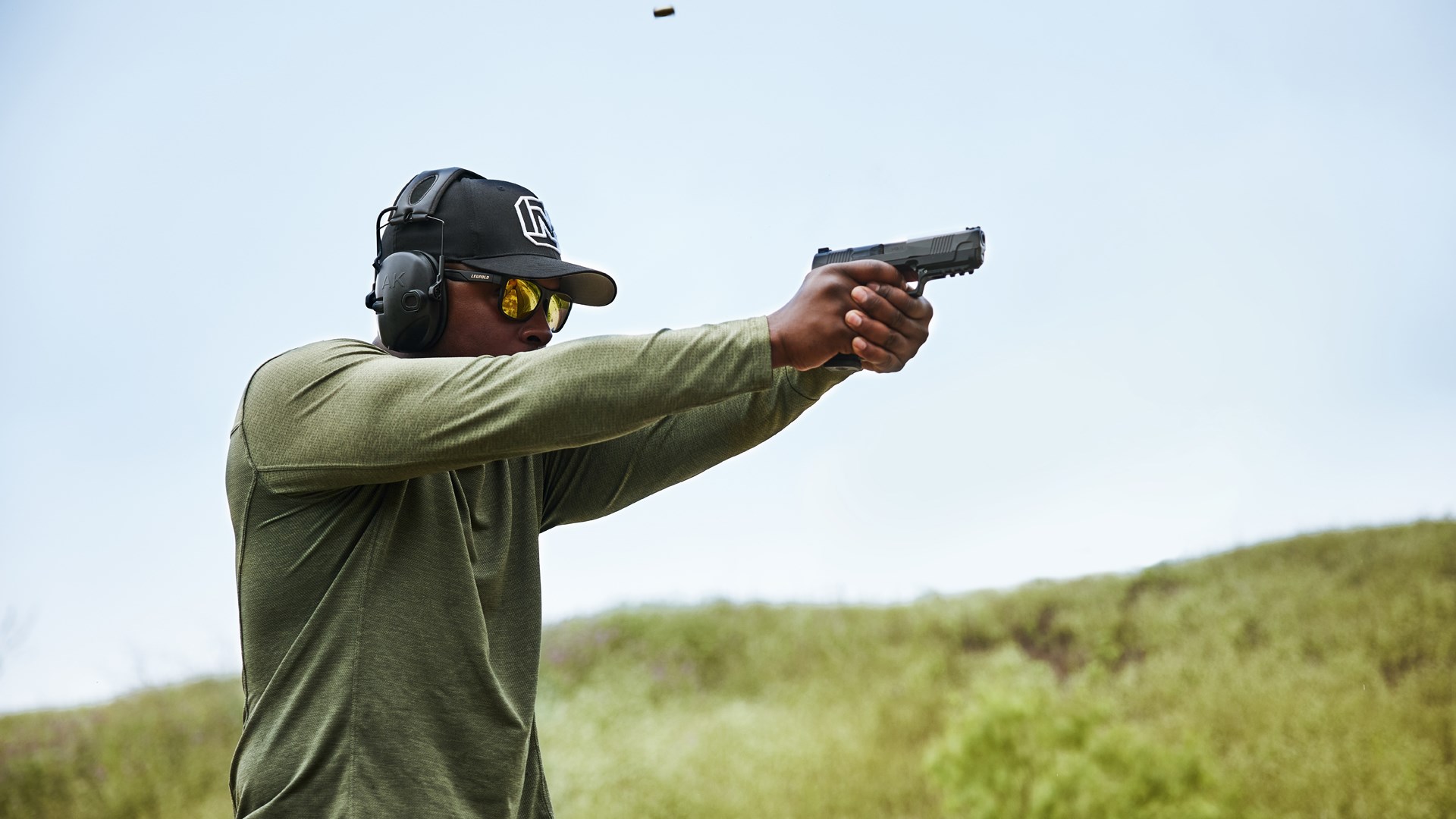 Man shooting Daniel Defense H9 on an outdoor range.