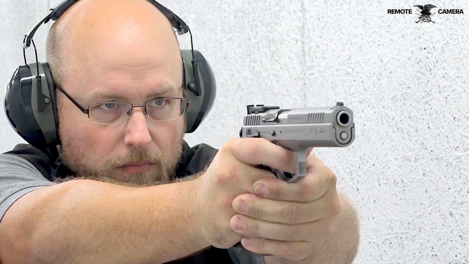 man glasses earmuffs shooting gun handgun pistol target range