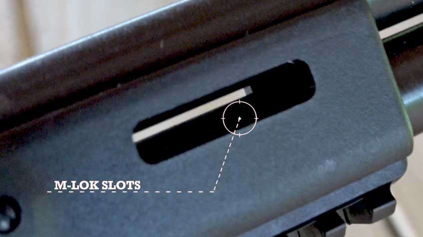 black plastic gun parts slot text noting m-lok slot