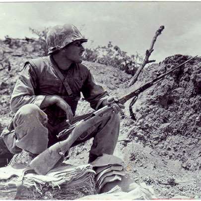 War trophy: A Leatherneck of the 5th Marines looks over a captured Mosin-Nagant M1944 carbine with its spike bayonet in June 1952.