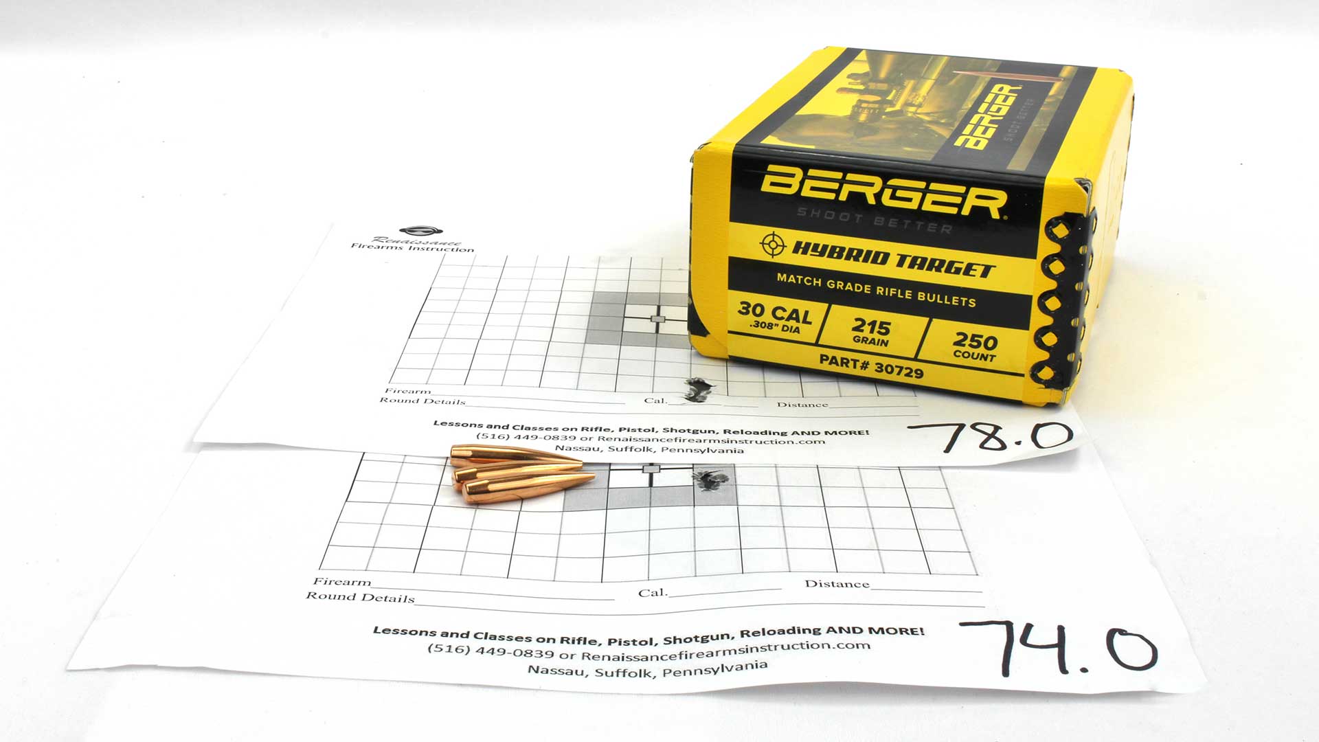 Berger Hybrid Target bullets laying on a shot target showing a tight, accurate group.