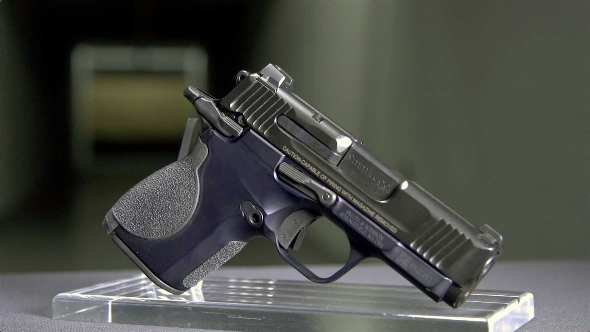 Right side of the Smith & Wesson CSX shown on a table with a dark range in the background.