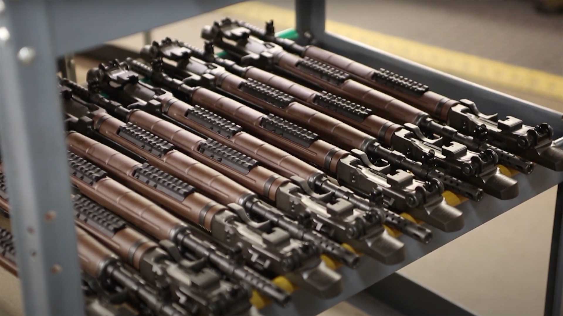 A rack of Springfield Armory Inc. M1A Squad Scout assembled receivers at the factory.