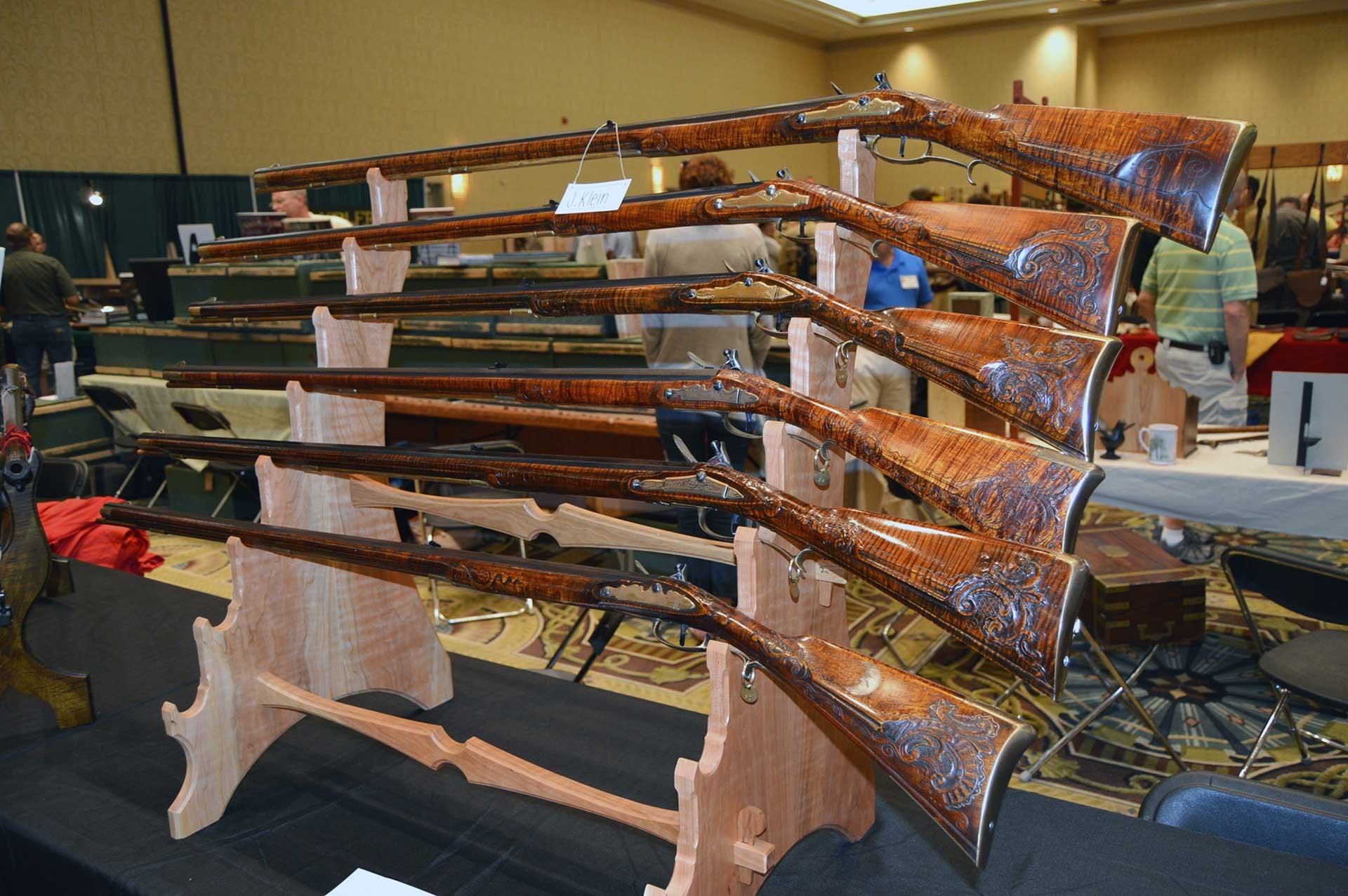 Flintlock longrifles shown on a stand at the CLA Show.