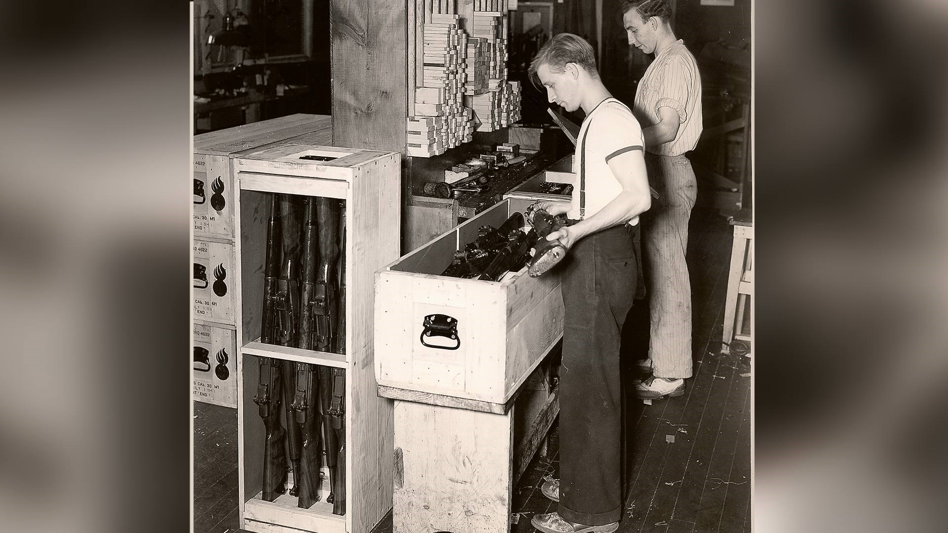 men packaging military winchester rifles for the war effort
