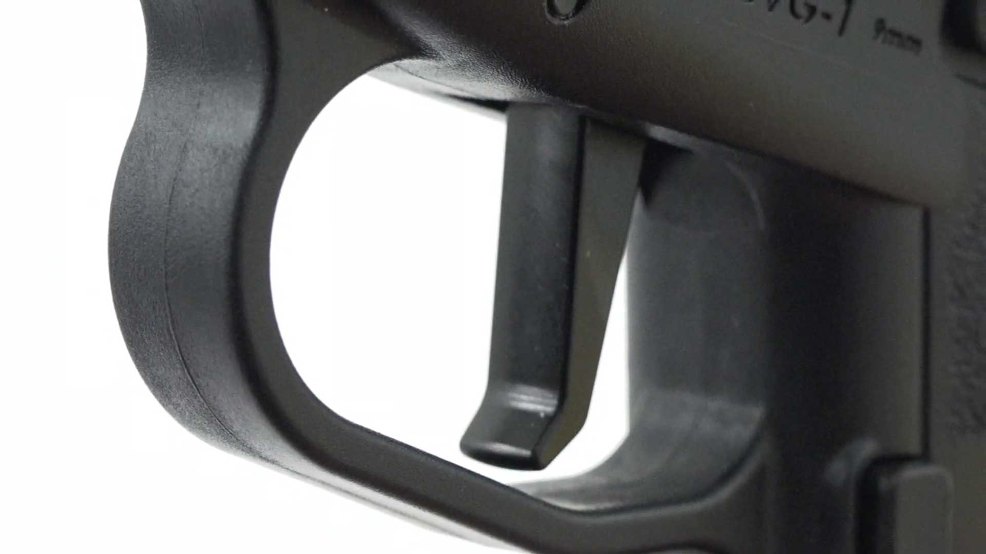 black plastic polymer pistol handgun frame trigger closeup