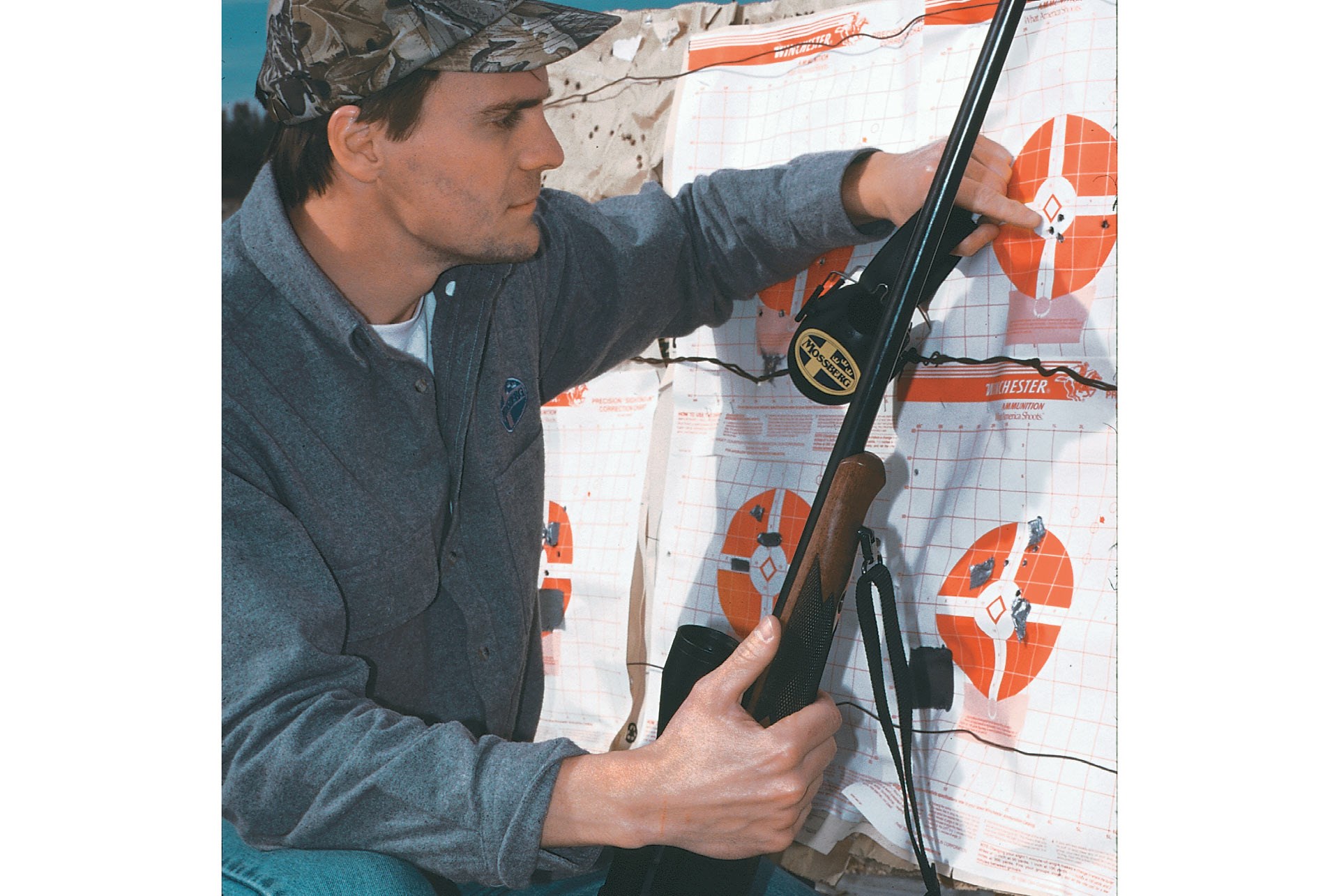 man with rifle pointing at target groups