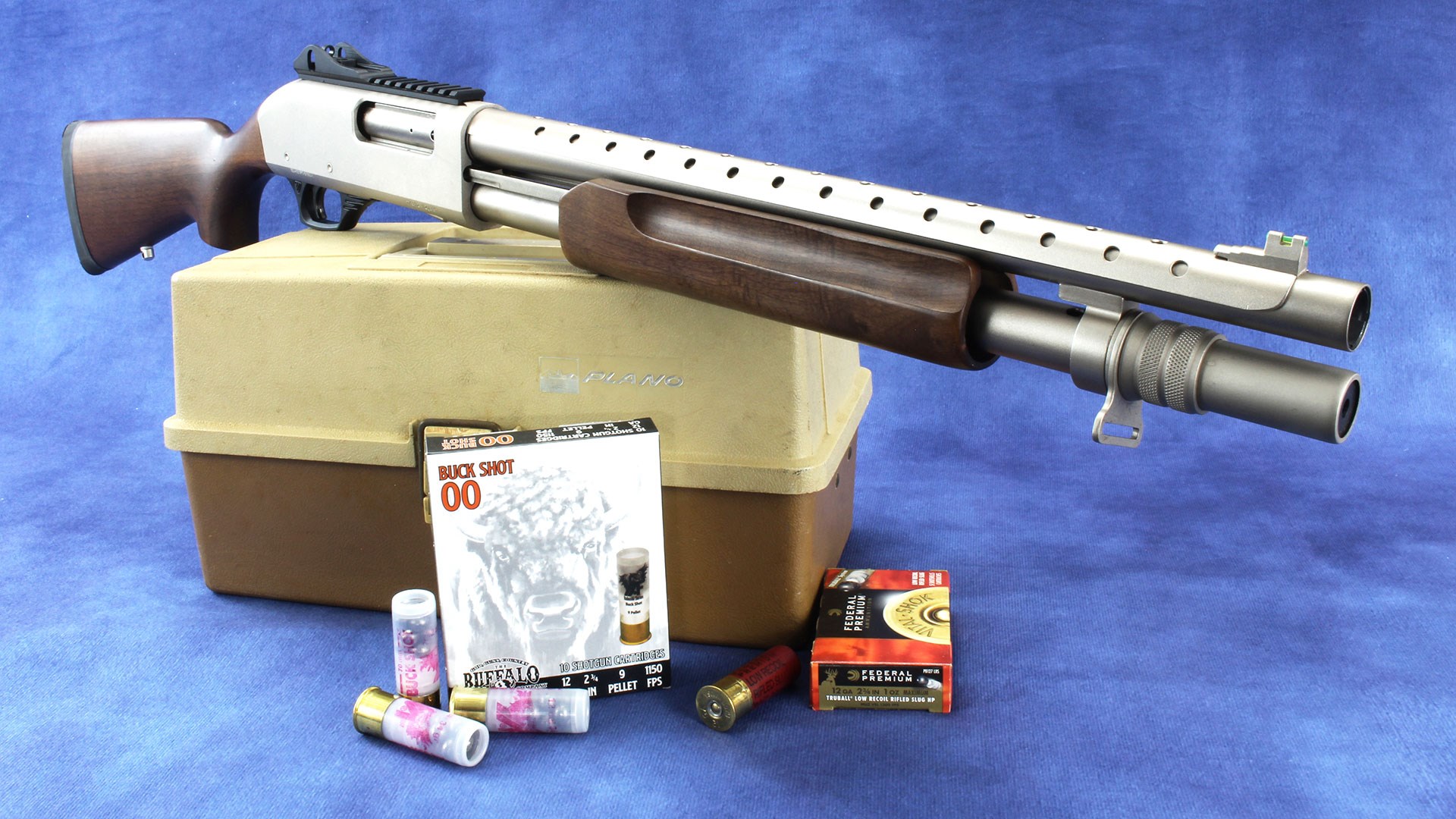 The Tokarev USA TX3 12HMD, silver in color with walnut stock, with ammunition and a tackle box.