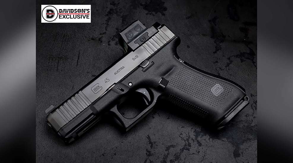The Gunsite Glock Service Pistol's left side shown while lying on a black background.