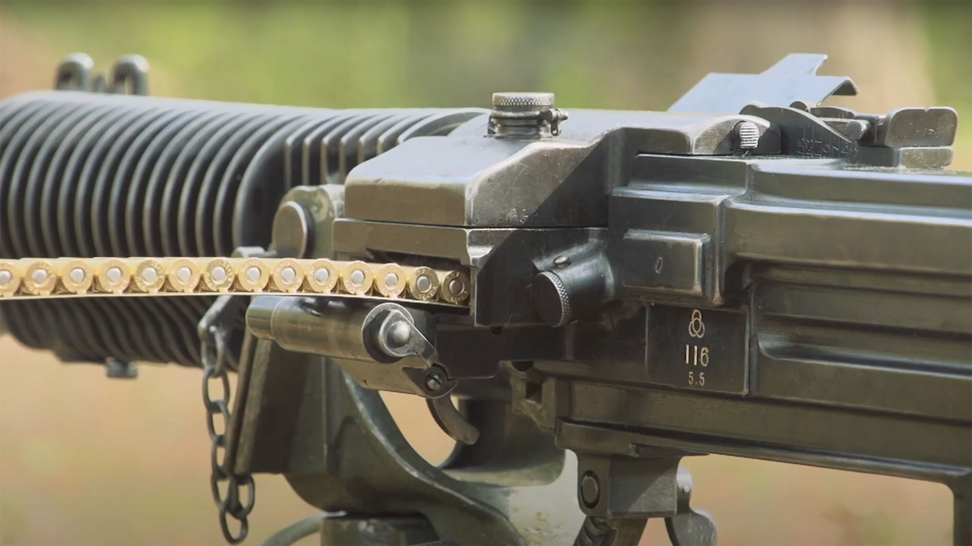 A close-up view of an ammunition feed strip inserted into a Japanese Type 3 heavy machine gun.