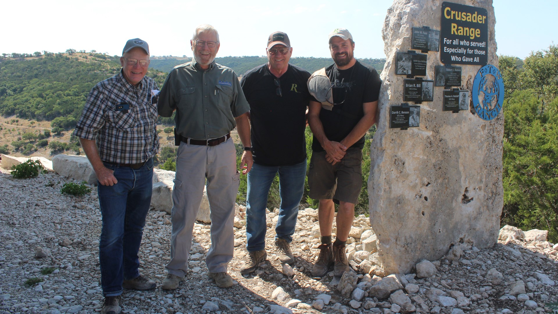 Left to right, Boddington, Tim Fallon, Ken D’Arcy and Mike Schoby at the “Crusader Range” on Fallon’s FTW Ranch next to a monument to FTW/SAAM students and friends who have been killed in action in Southwest Asia.