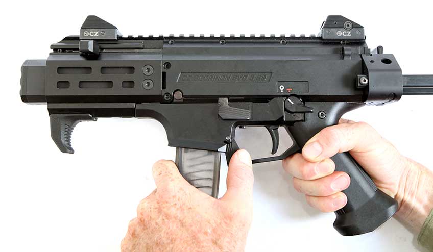 The magazine release on the CZ Scorpion is an ambidextrous paddle-type arrangement that can be actuated by the thumb of the support had when grasping the magazine for retention.