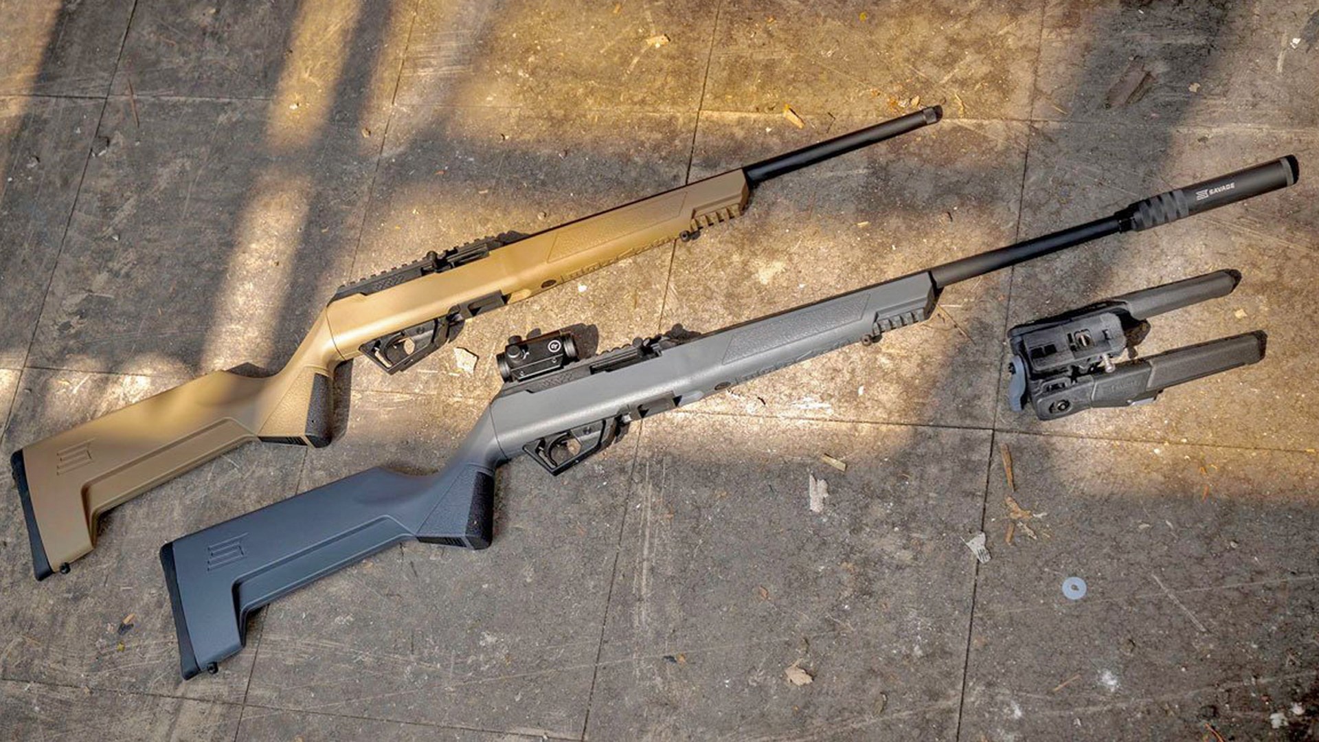 Two Savage Arms RXR22 rifles lying on a tiled surface.