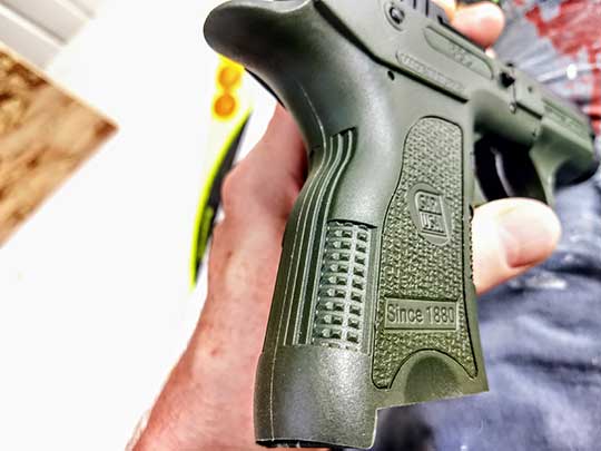 The olive drab green frame of the specific B6C tested. Note the textured grip surfaces.
