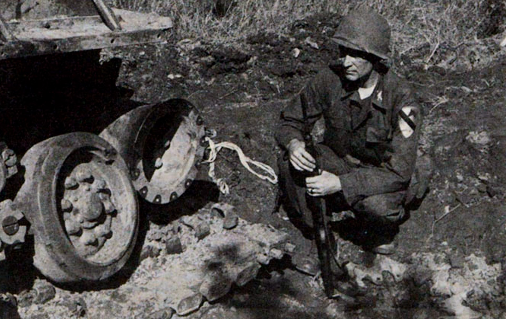 Author carried an M1 carbine as a staff officer in 70th Tank Bn., 1st Cavalry Division in the Korean War. Here he examines U.S.M4E8 medium tank damaged by Chinese anti-tank mine near Chorwon, N. Korea, Sept., 1951.