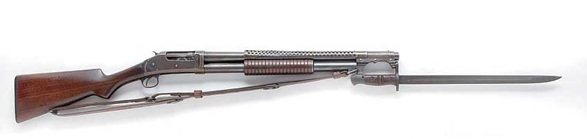 The John Browning designed Winchester Model 1897 shotgun was first adopted by the U.S. military circa 1900.