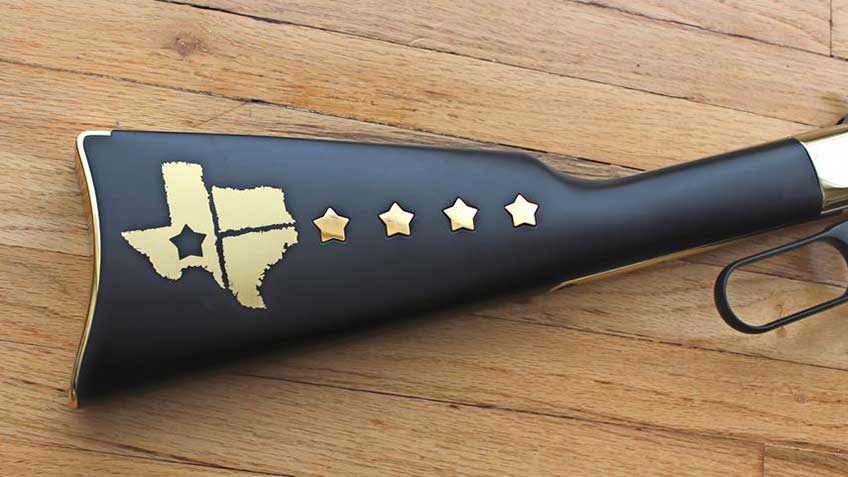 Right side of Henry Texas Tribute Golden Boy rifle stock, showing five inlaid stars along with a brass inlay shaped like the state of Texas.