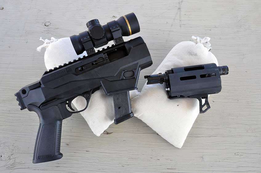 Ruger PC Charger pistol disassembled on sandbags. Leupold RDS optic attached to rail.
