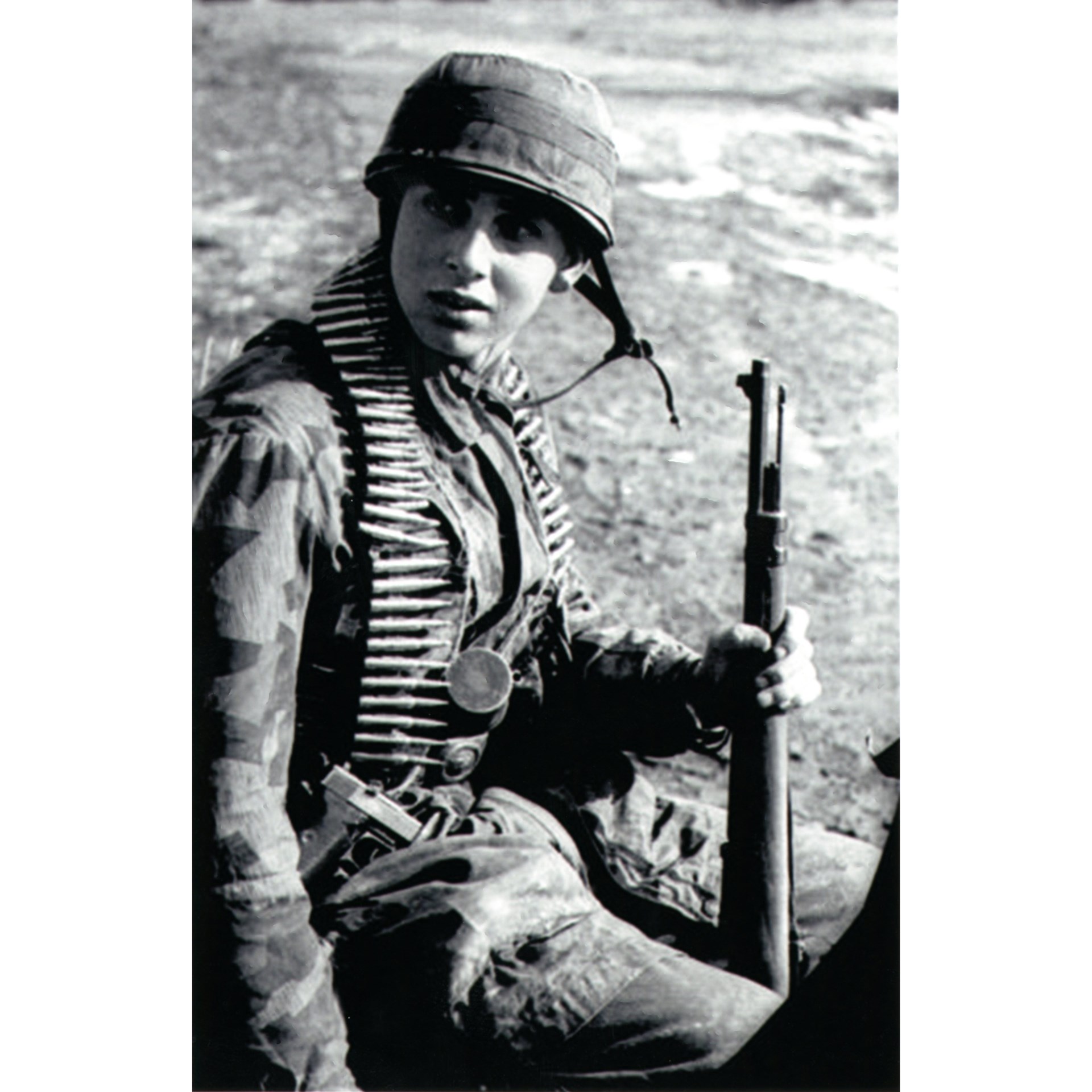 A heavily-armed young paratrooper on the Gran Sasso raid. He carries a Kar 98k Mauser rifle (7.92mm) and a Walther P-38 pistol (9mm), along with a belt of 7.92mm ammunition for his squad’s MG34 or MG42—normally, the squad carried about 1,800 rounds of ammo between them to support the MG as their base of fire. Note that he also carries the Stielhandgranate 24. Author’s collection