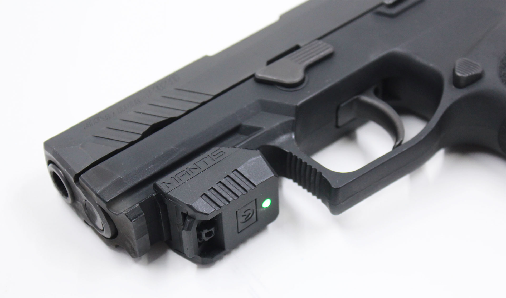 One of the Mantis laser training modules, the X3, attached to the Picatinny rail of a SIG Sauer P320.