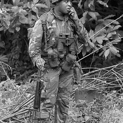 A Marine radio operator on Grenada armed with a M16A1.