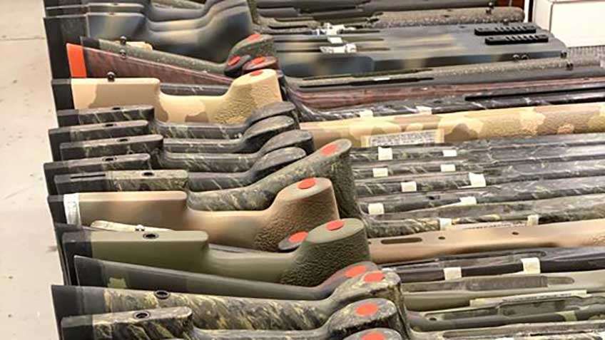 McMillan gun stocks rifle stocks parts camouflage row stack
