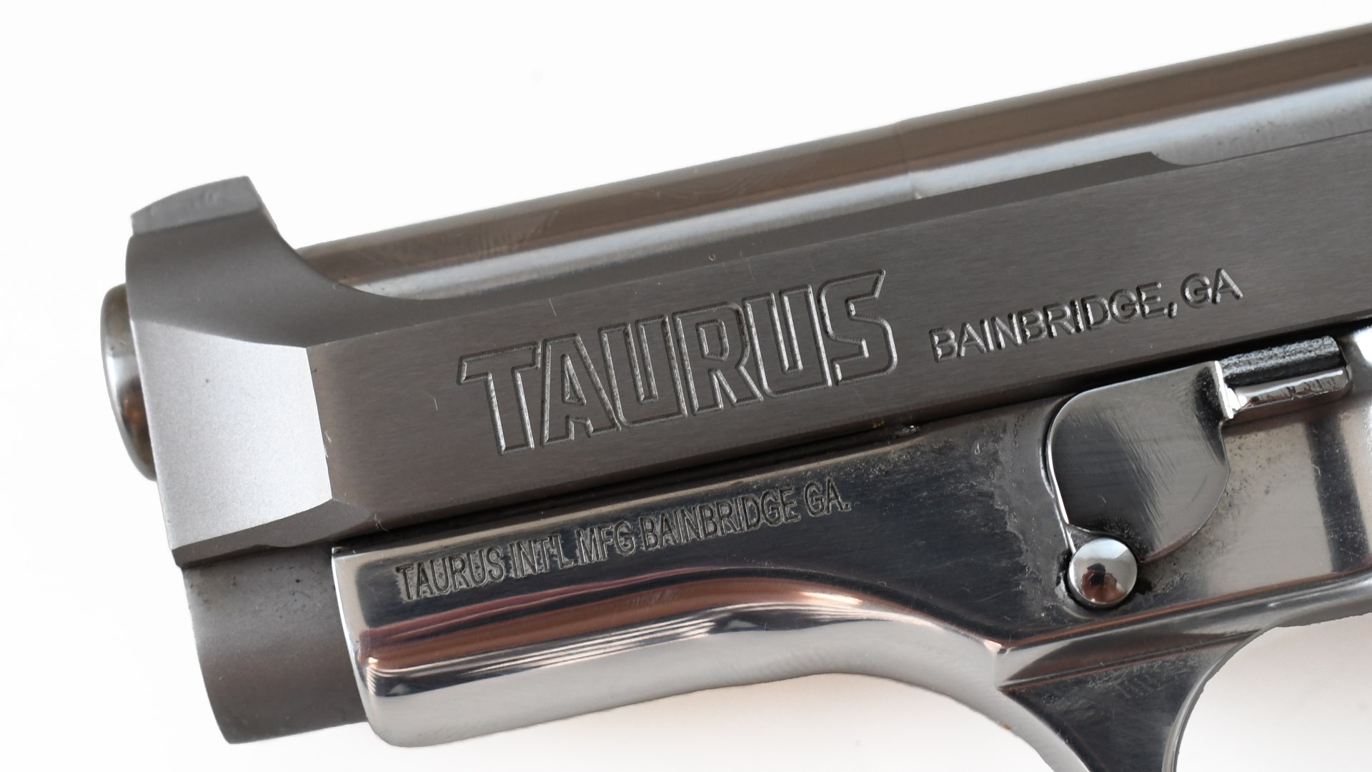 Taurus Model 58 handgun left-side view slide marking closeup near muzzle silver color gun on white background
