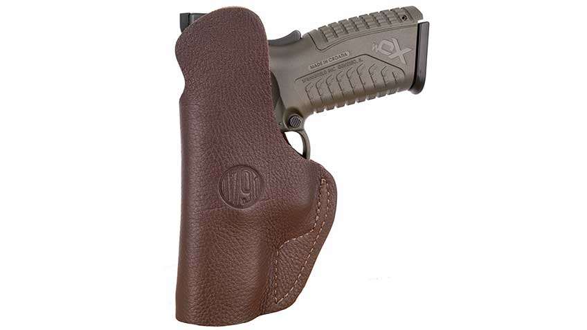 Left-side view on white background of Springfield Armory XDm pistol in 1791 Gunleather brand holster