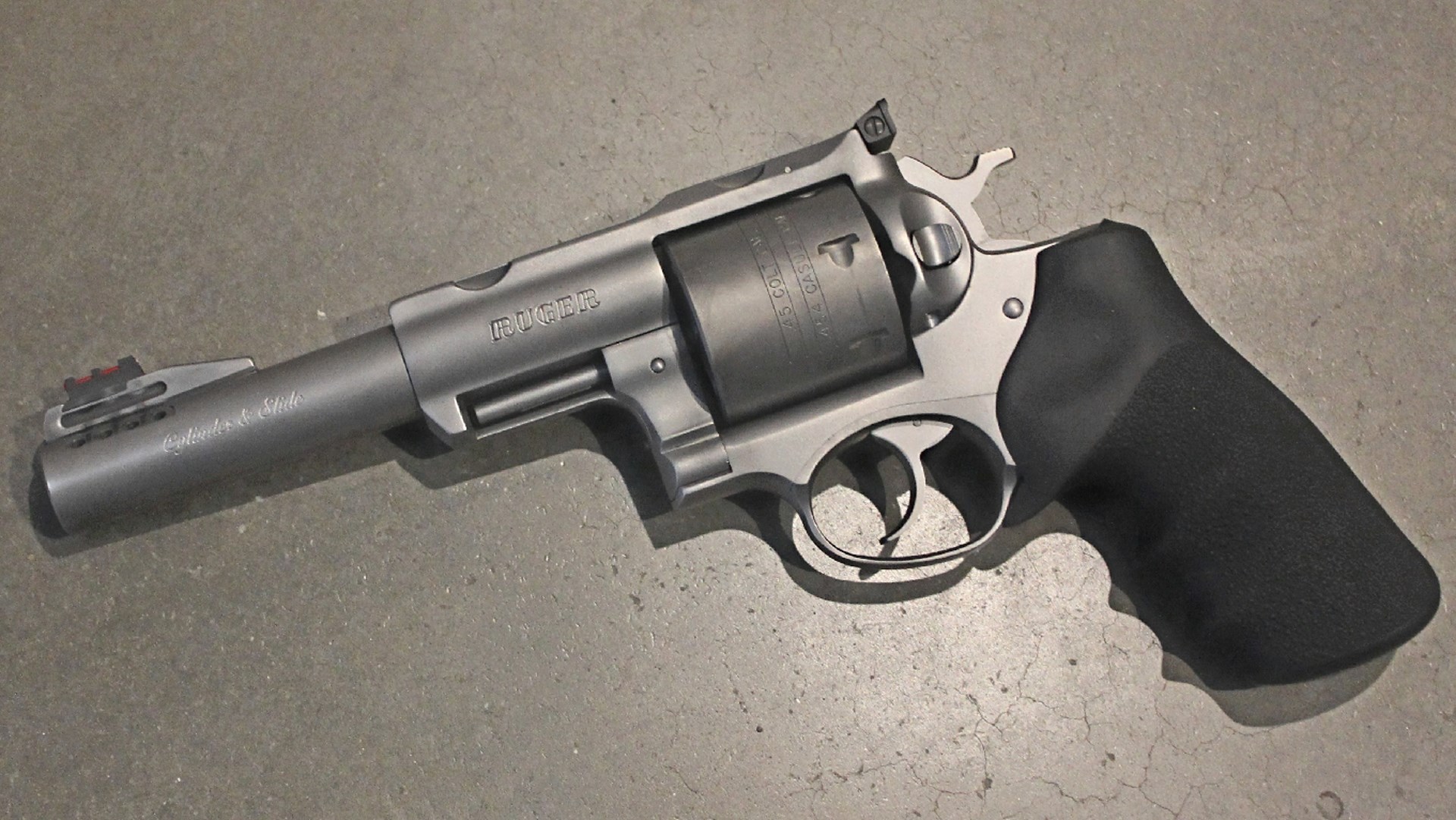 Left-side view Ruger stainless steel revolver custom cylinder and slide stamping black rubber grip