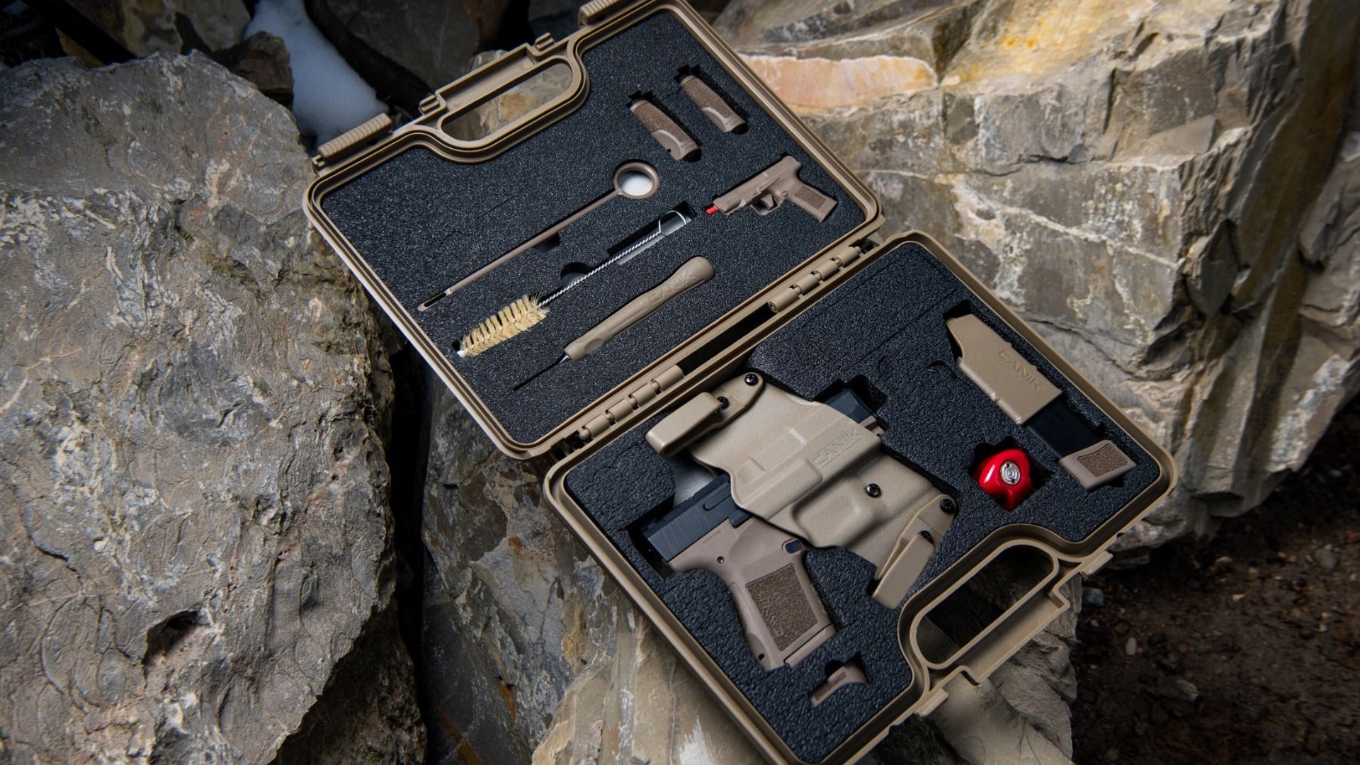 Canik Mete MC9 pistol sitting inside a black plastic hard case with cleaning tools, an extra magazine and a holster.