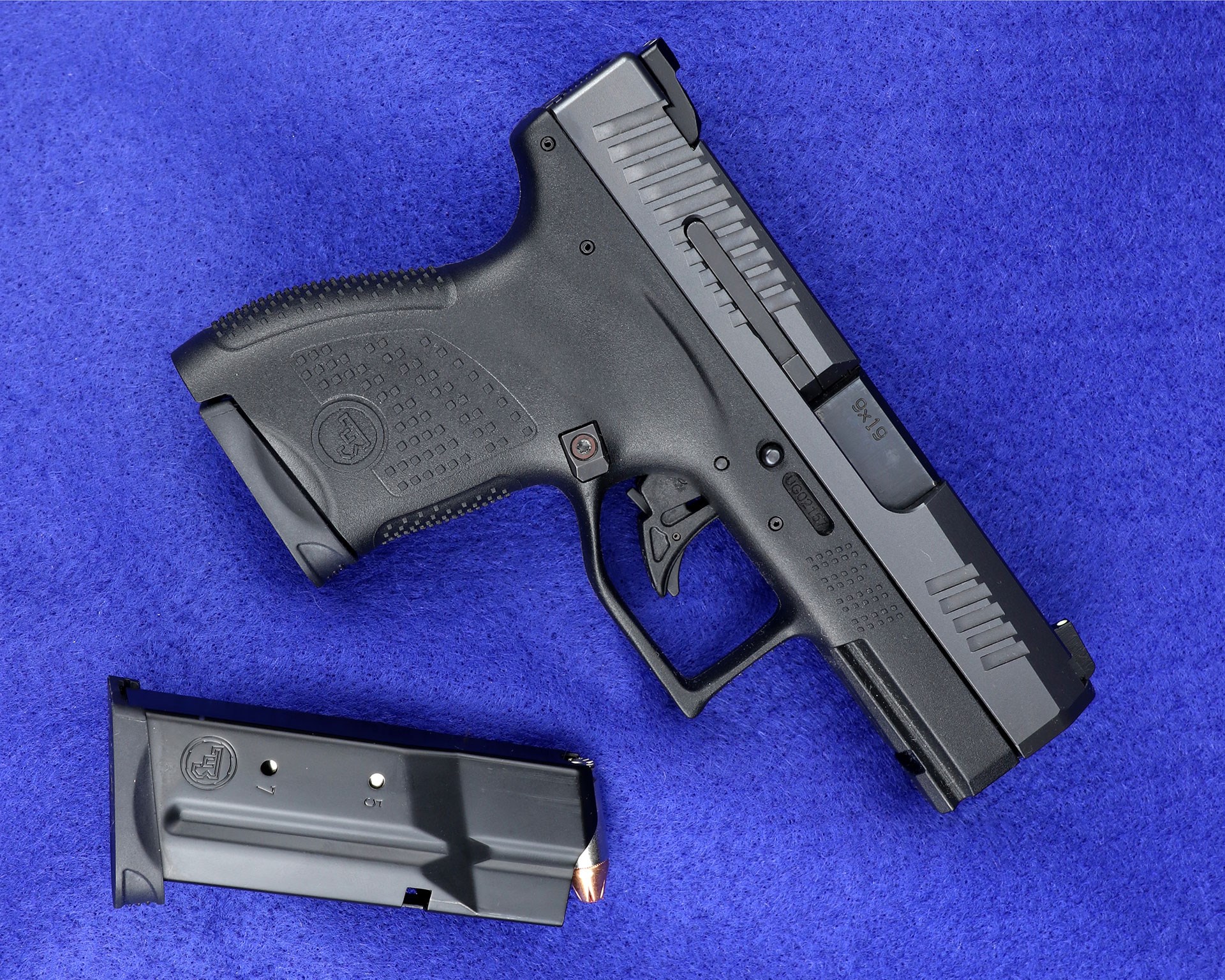 CZ P-10 M black 9 mm handgun with blue background and magazine removed.