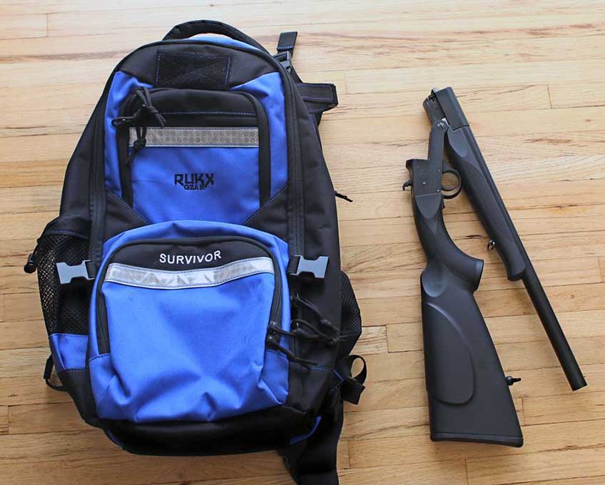 backpack black blue next to ATI shotgun