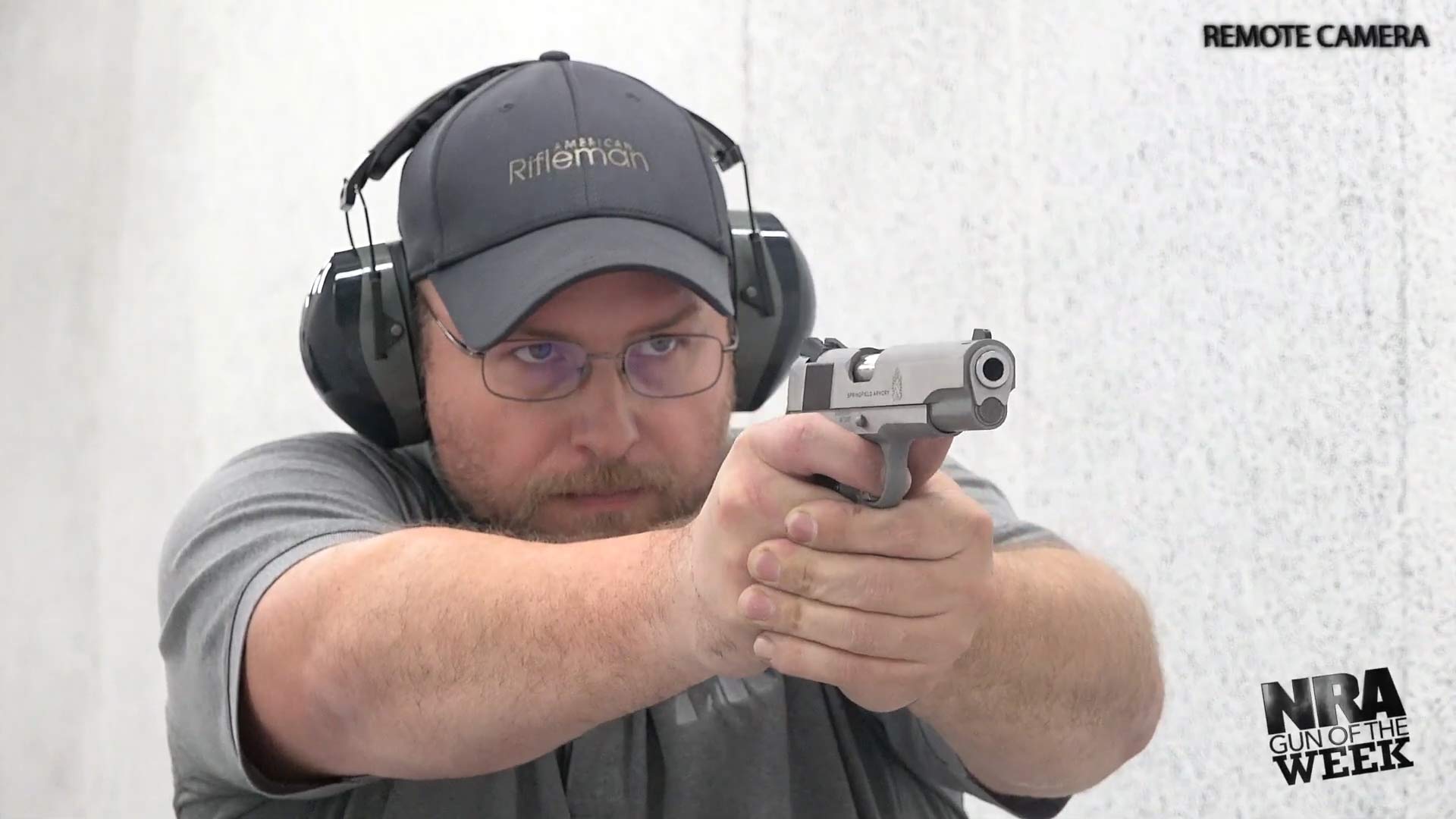 Man shooting silver stainless steel Springfield Armory Garrison pistol M1911 .45 acp