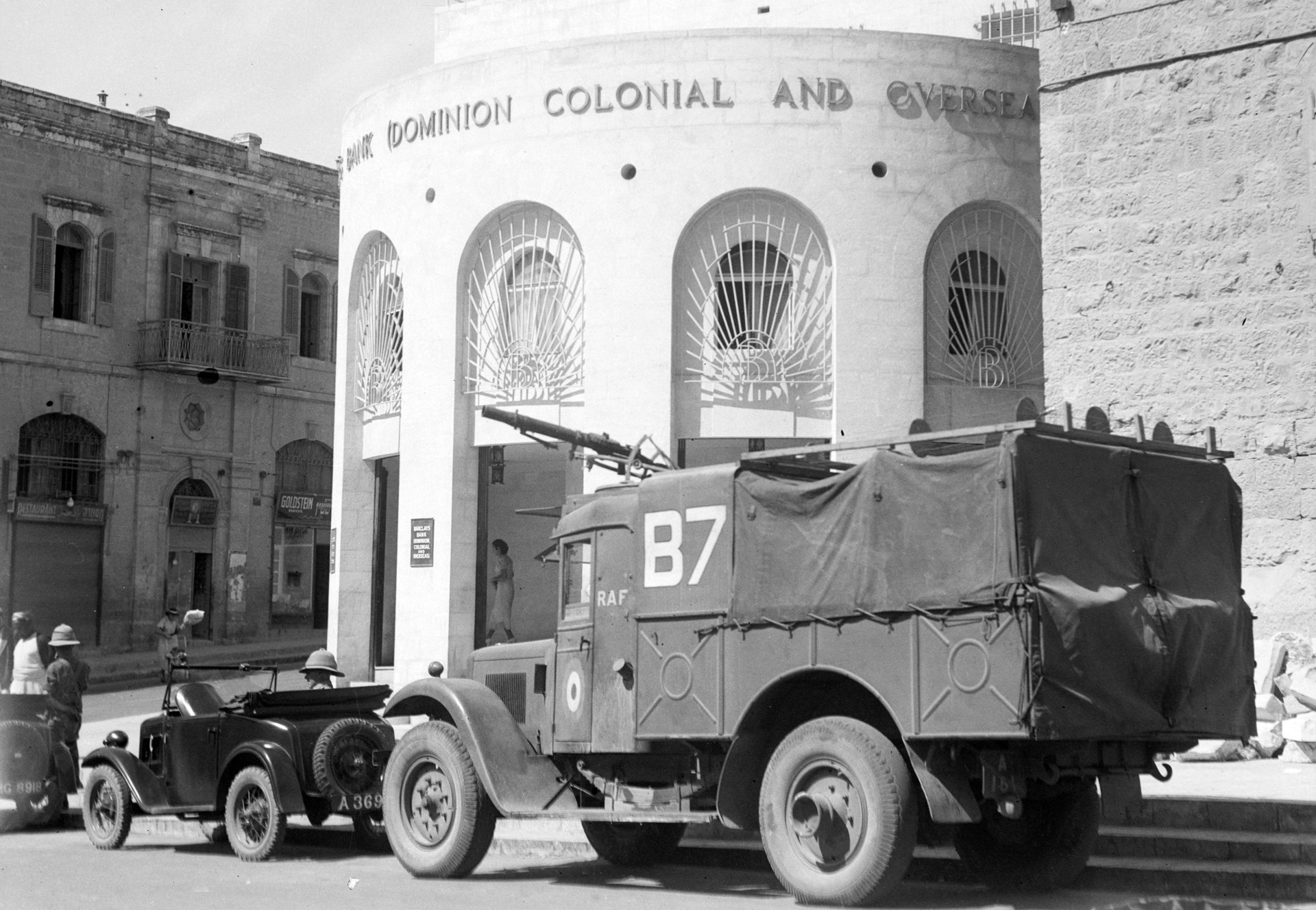 A great deal of British force’s attention was consumed by convoy escort, protecting government, transportation, and communications facilities, and securing financial institutions.  These RAF vehicles are seen outside Barclays Bank.  Note the Lewis gun in a traversing AA mount.  Library of Congress