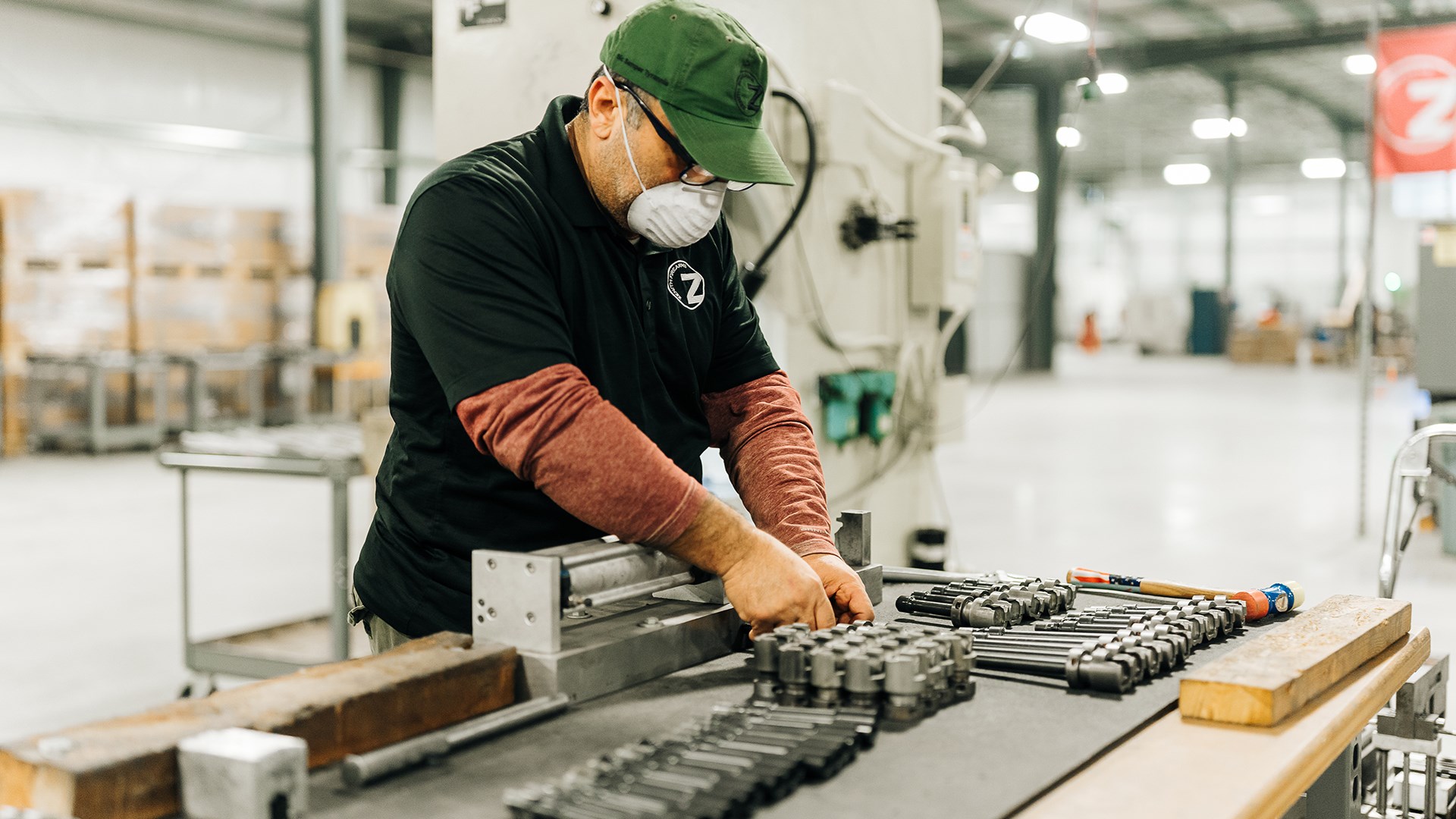 Zenith factory worker wearing PPE sorting parts on table