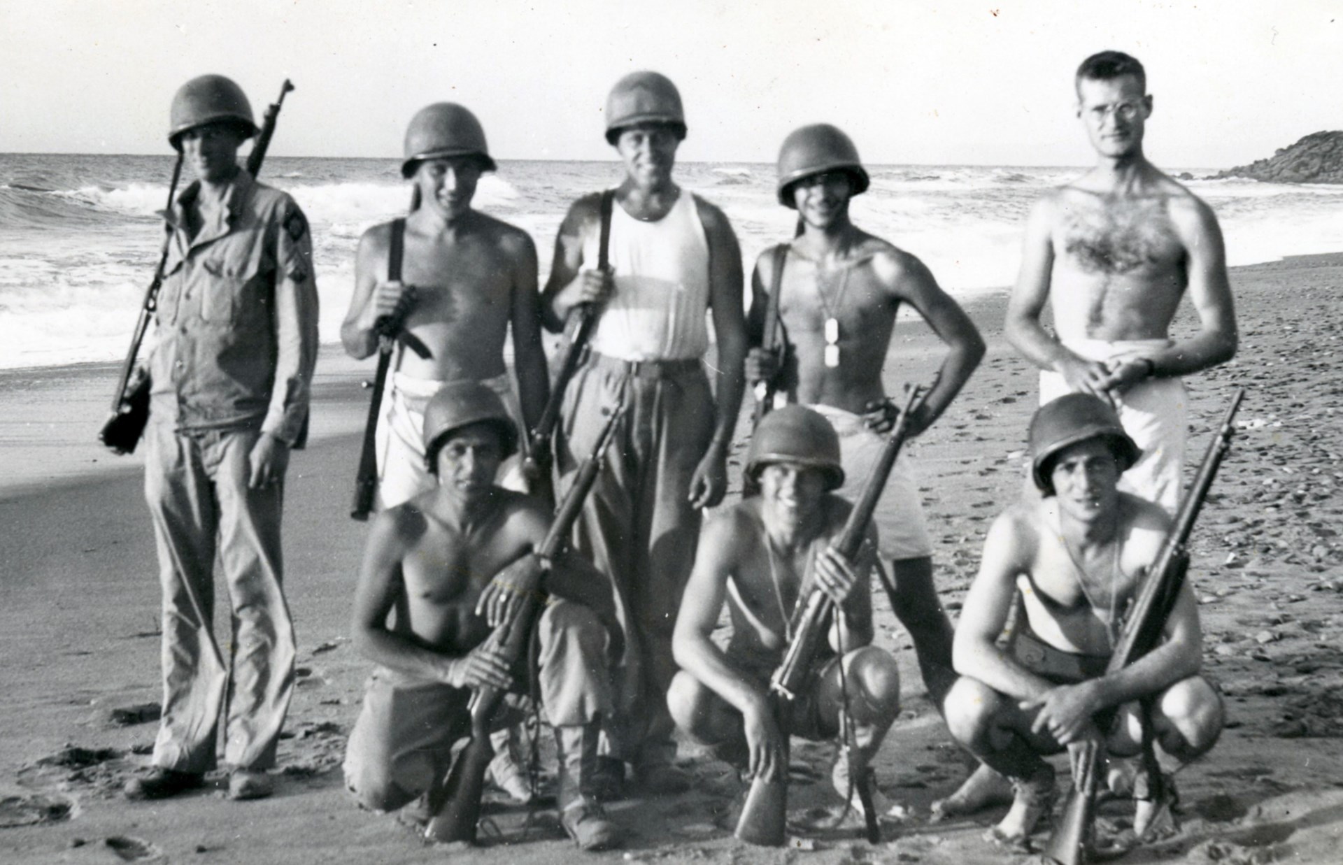 Enjoying the sun and surf on a Sicilian beach, these GIs carry a mix of M1 Garand and M1903 Springfield rifles. Author’s collection