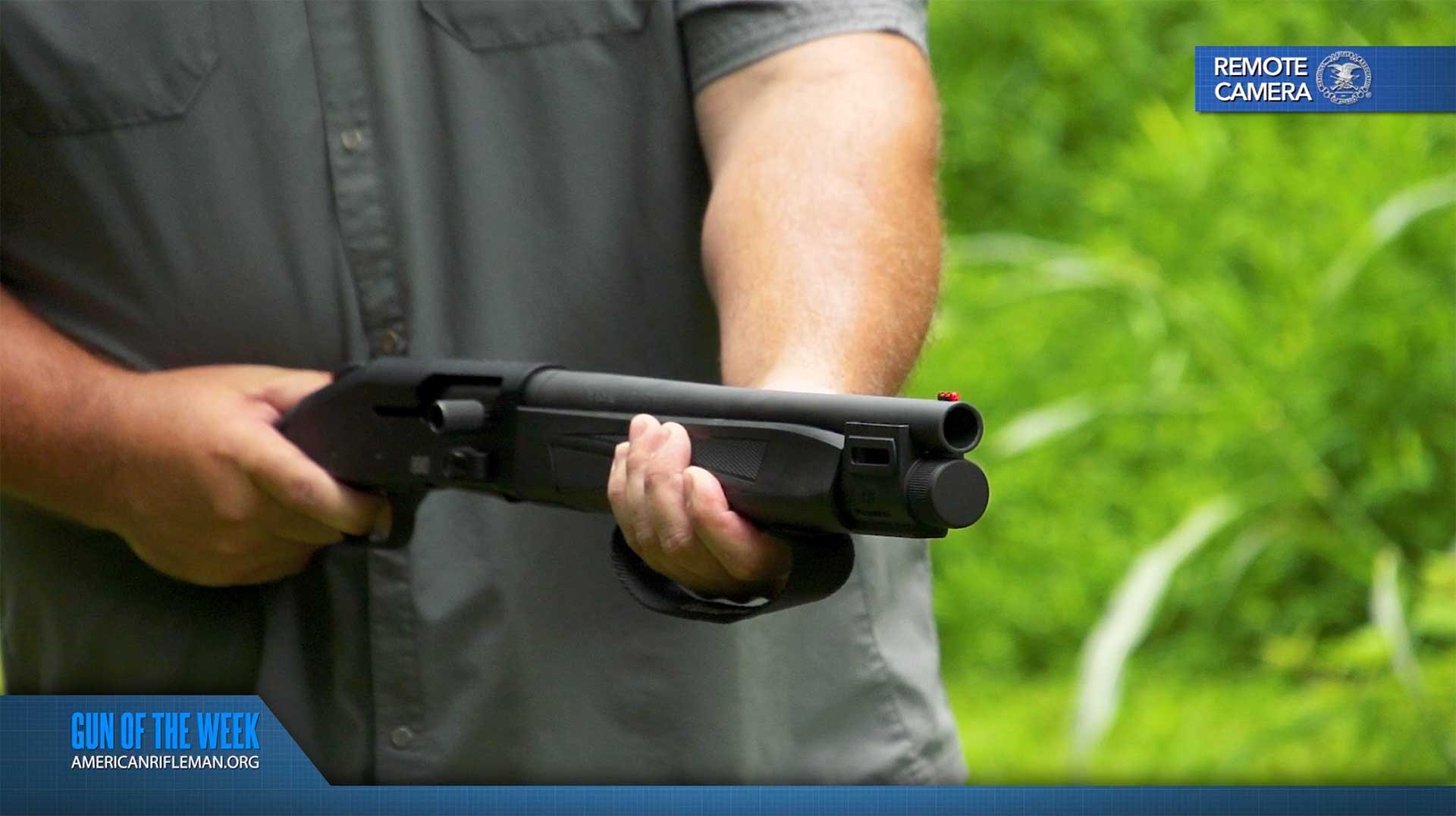 Man aiming the Mossberg 990 Aftershock from the hip on an outdoor range.