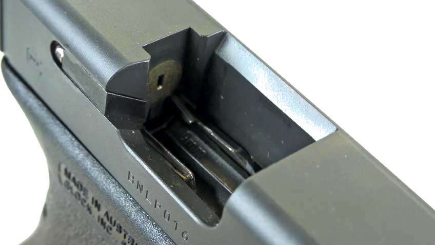 Black pistol slide metal open square hole white background