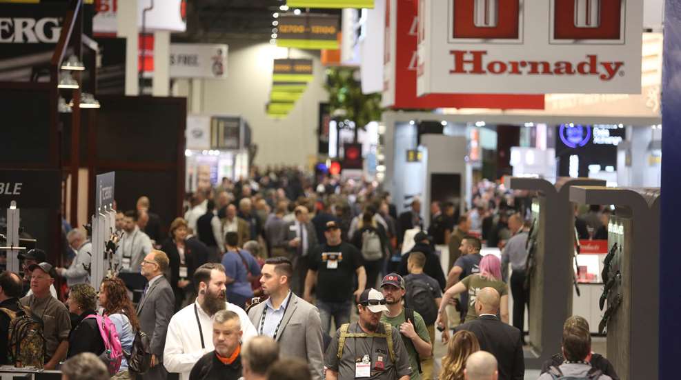 People gathering indoors trade show signage HORNADY