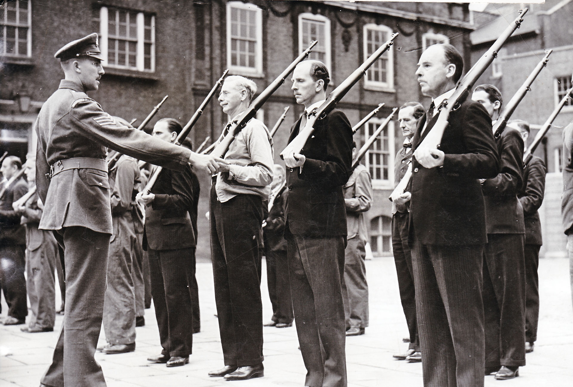 Dad’s Army:  Home Guard men drill in civilian clothes with P14 rifles. NARA