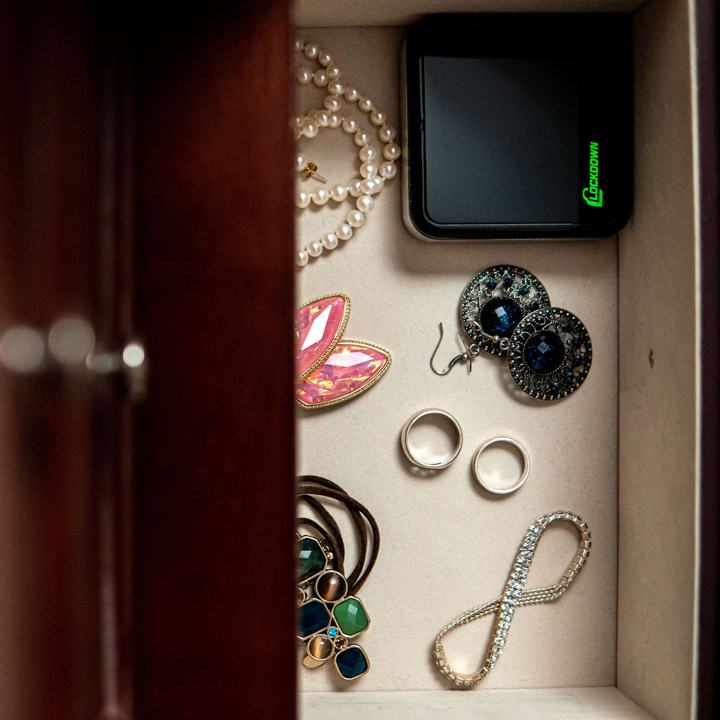 Open drawer with jewelry and Lockdown Puck for security.