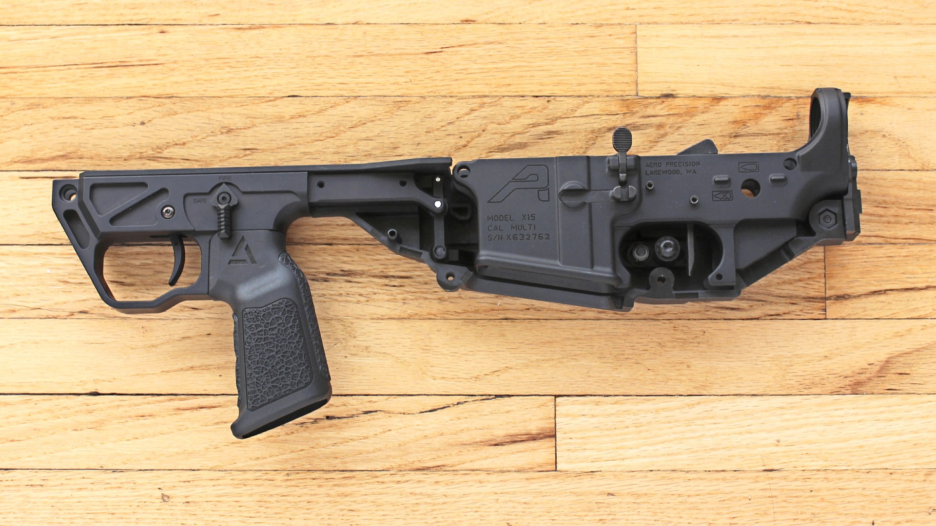 A3 Triad Bullpup chassis left-side view shown with Aero Precision lower receiver AR15 shown on wood flooring