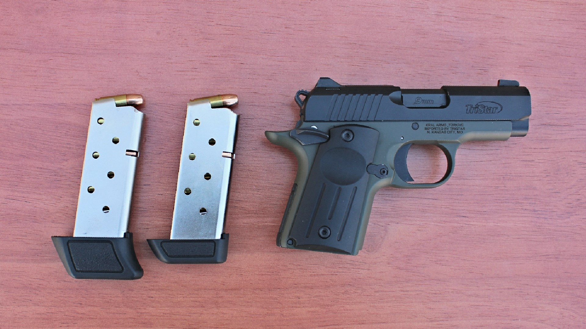 TriStar Arms Protege X next to two loaded magazines.