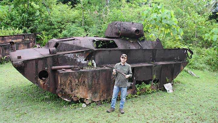 The author poses in front of an LVT(A)-4 AmTrac located near the end of one of the runways of Peleliu’s old airfield while holding the upper receiver of a relic condition M1928A1 Thompson submachine gun.