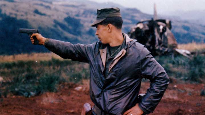 A Leatherneck of the 3rd Marine Division at Khe Sanh test fires his issue M1911A1 pistol along the perimeter of that infamous position prior to the 1968 siege.