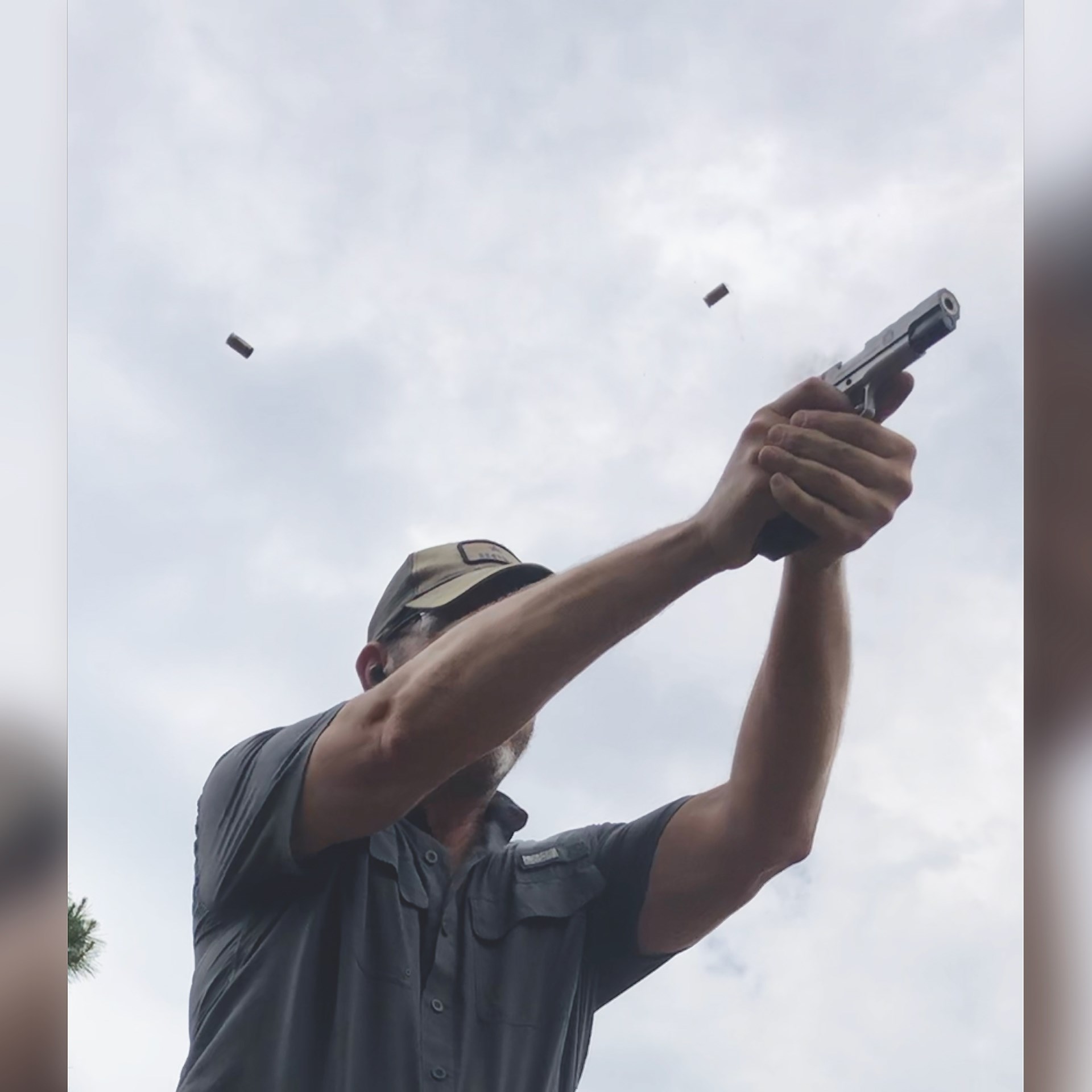 upward angle of man shooting pistol