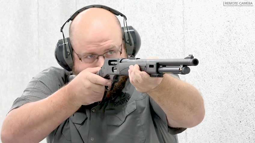 man holding rifle shooting earmuffs glasses black gun