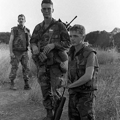 The barefoot grenadier: an M16/M203-armed soldier enjoys the weather on Grenada.